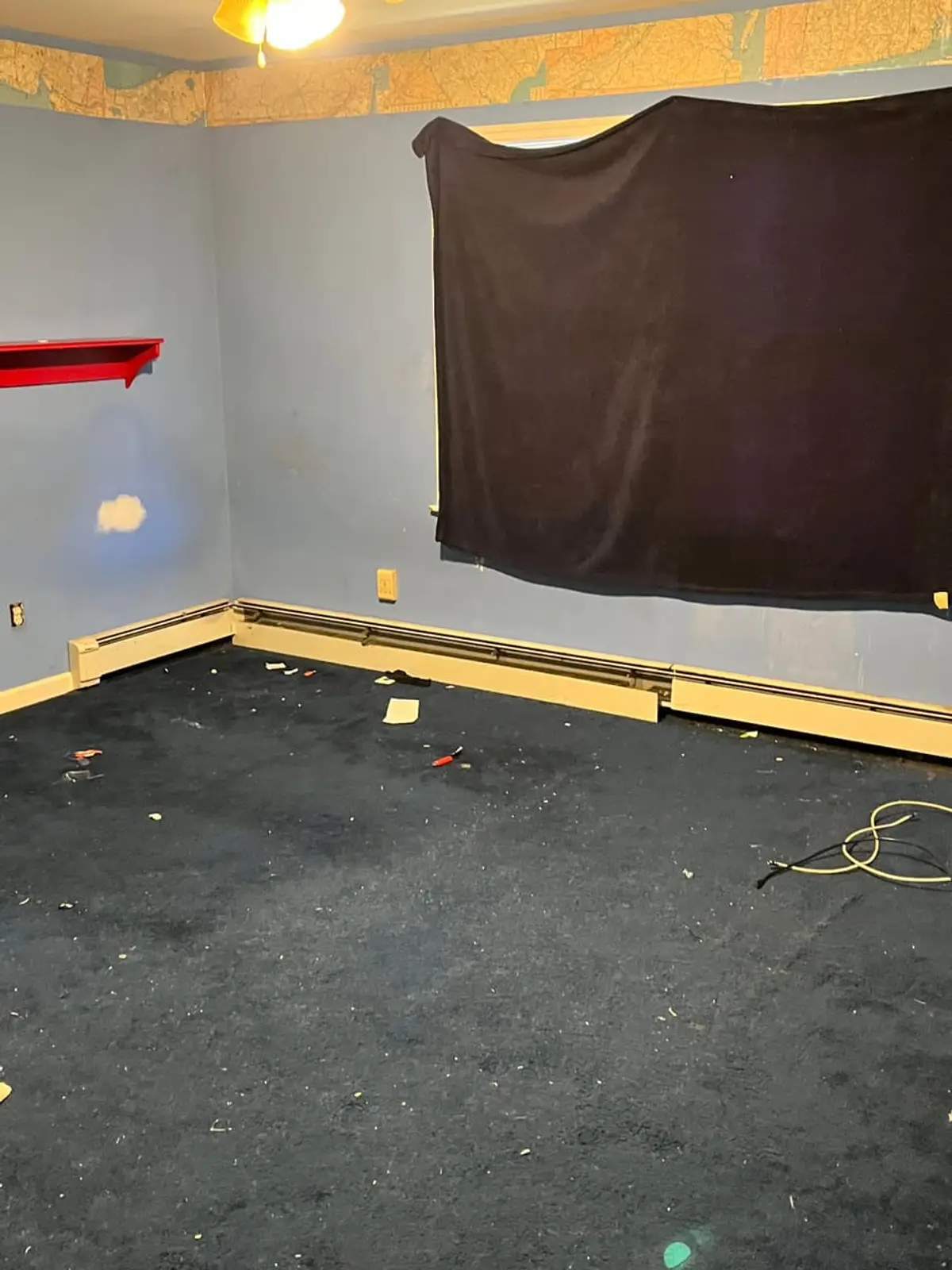 Selling a house with back taxes in Islip: empty bedroom with stained navy carpet and loose cords