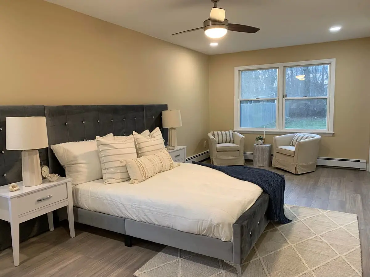 Selling a house for a job relocation in Islip: finished bedroom with fresh paint and new flooring