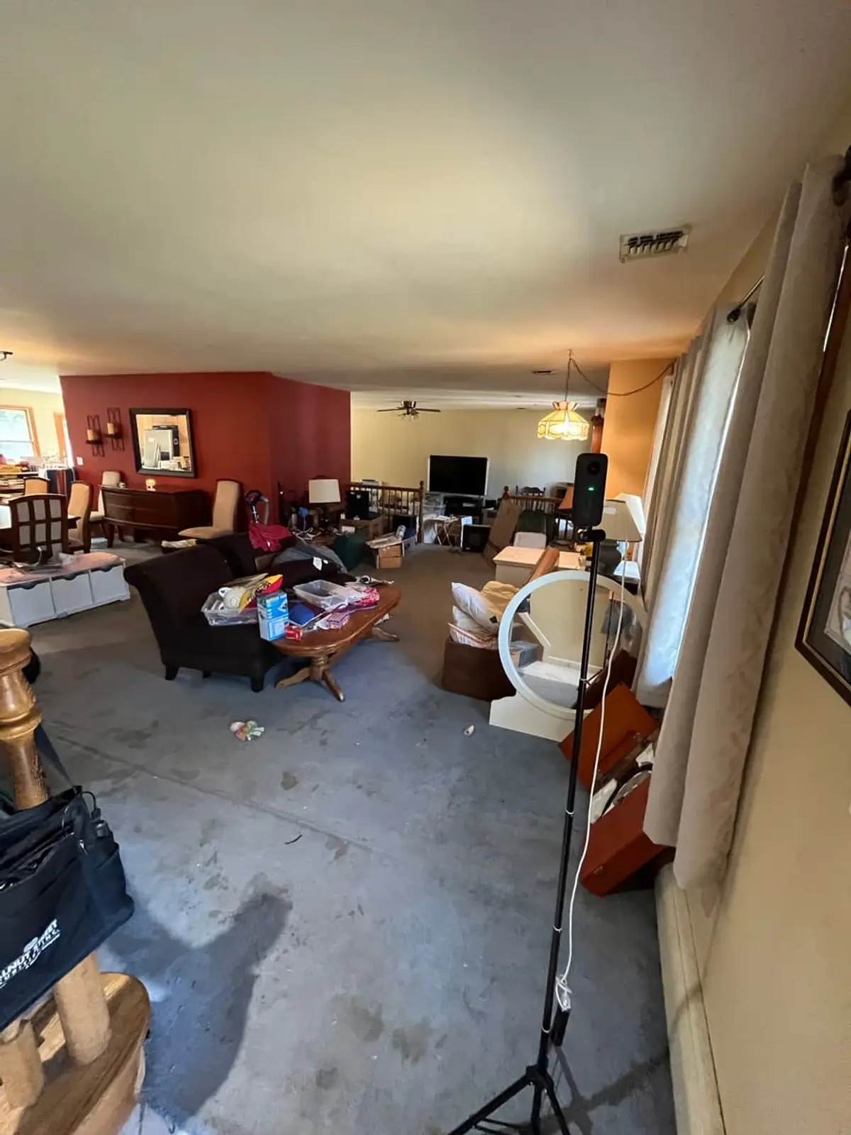 Dealing with squatters or holdover tenants in Islip: open living room cluttered with furniture, boxes and bags