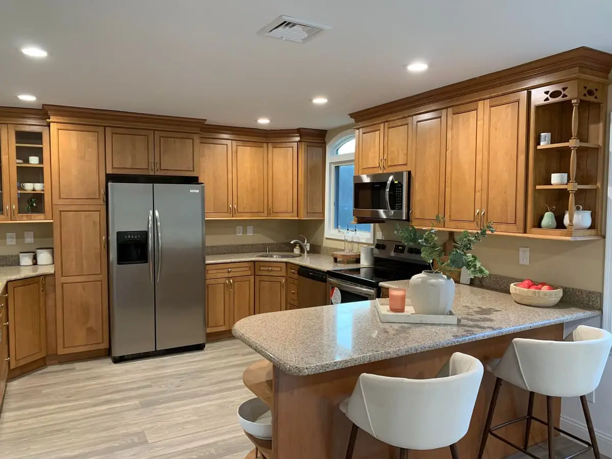 Selling a multi-family house in Islip: renovated kitchen with wood cabinets, stainless appliances and an island